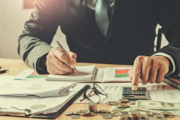 Financial Planner at a desk with charts and money