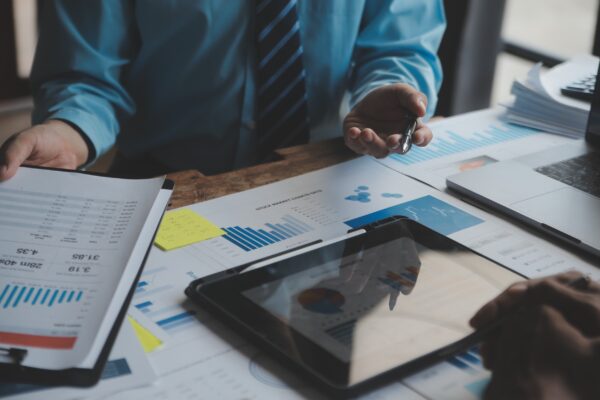 Financial analysts analyze business financial reports on a digital tablet planning investment project