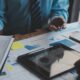 Financial analysts analyze business financial reports on a digital tablet planning investment project