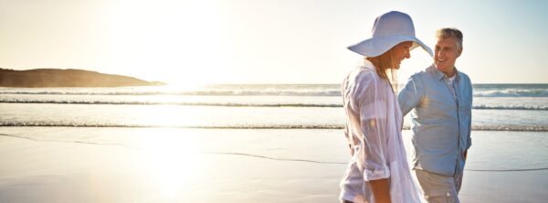 Senior retired couple on the beach at sunset